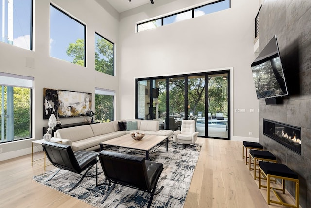 living room featuring a towering ceiling and plenty of natural light