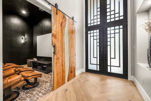 foyer featuring french doors and a barn door