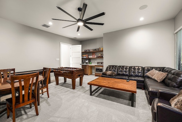 living room with light carpet and ceiling fan