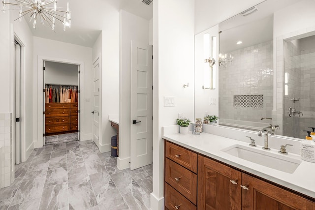 bathroom with vanity, separate shower and tub, and a chandelier