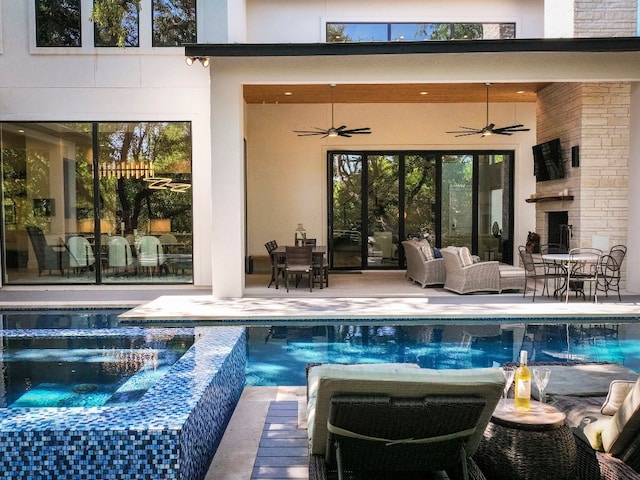 view of swimming pool featuring a patio area, ceiling fan, an in ground hot tub, and an outdoor living space