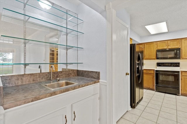 kitchen featuring sink, refrigerator with ice dispenser, white electric stove, a textured ceiling, and light tile patterned floors