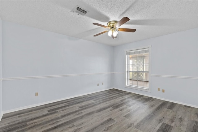 spare room with ceiling fan, dark wood-type flooring, and a textured ceiling