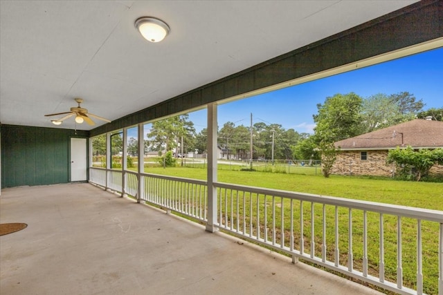 unfurnished sunroom with ceiling fan