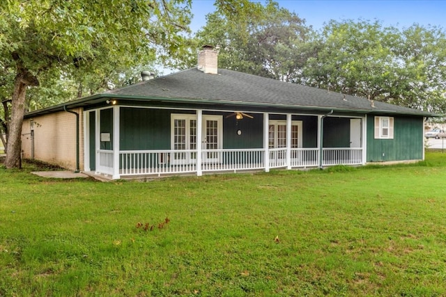 rear view of property featuring a yard