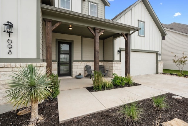 doorway to property featuring a porch and a garage