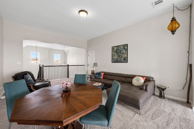 dining room featuring light colored carpet