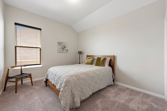 carpeted bedroom featuring lofted ceiling