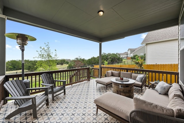 view of patio with an outdoor living space with a fire pit