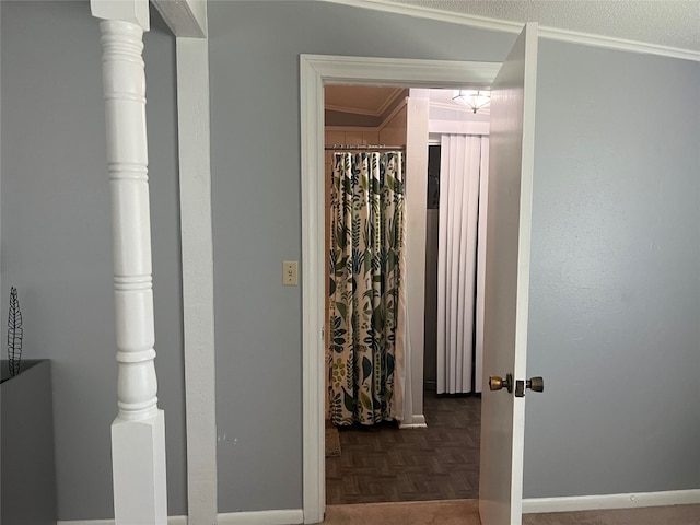 hallway with dark parquet floors and ornamental molding