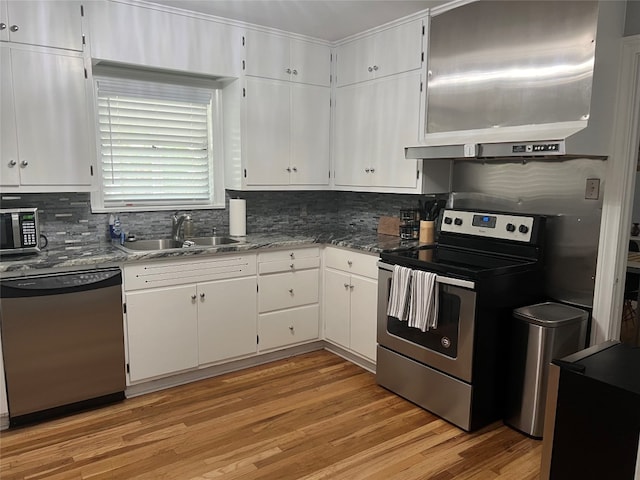 kitchen featuring light hardwood / wood-style flooring, white cabinetry, appliances with stainless steel finishes, and sink