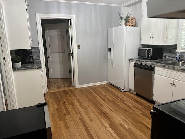 kitchen featuring appliances with stainless steel finishes, backsplash, light wood-type flooring, and white cabinetry