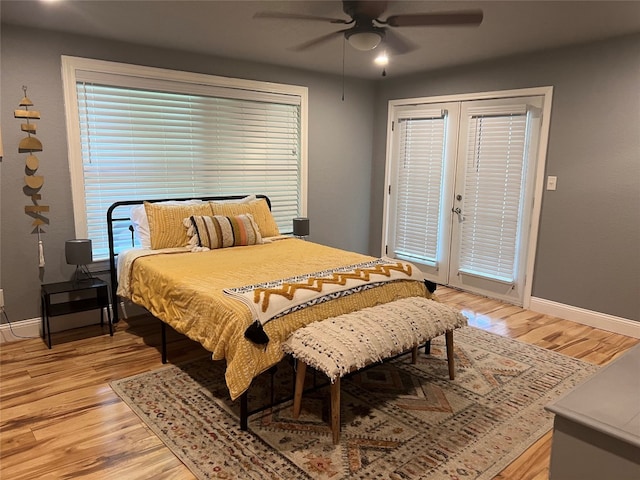 bedroom featuring french doors, light hardwood / wood-style flooring, access to exterior, and ceiling fan