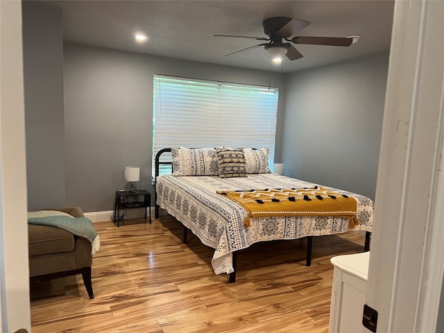 bedroom featuring light hardwood / wood-style floors and ceiling fan