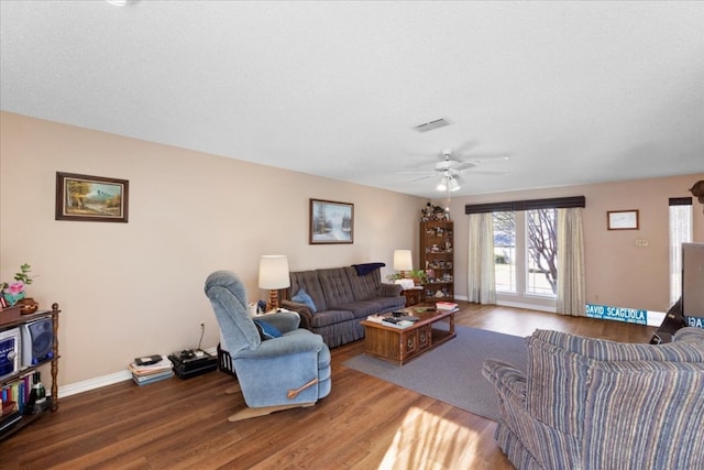 living room featuring hardwood / wood-style floors and ceiling fan