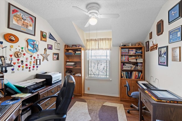 office area with ceiling fan, a textured ceiling, hardwood / wood-style flooring, and lofted ceiling