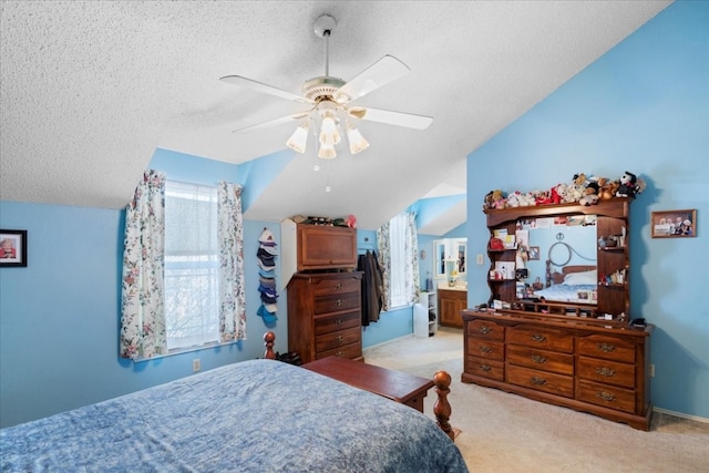 carpeted bedroom with ensuite bath, ceiling fan, a textured ceiling, and lofted ceiling