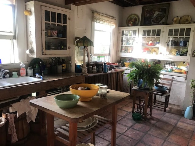 kitchen with white cabinetry, sink, and radiator heating unit