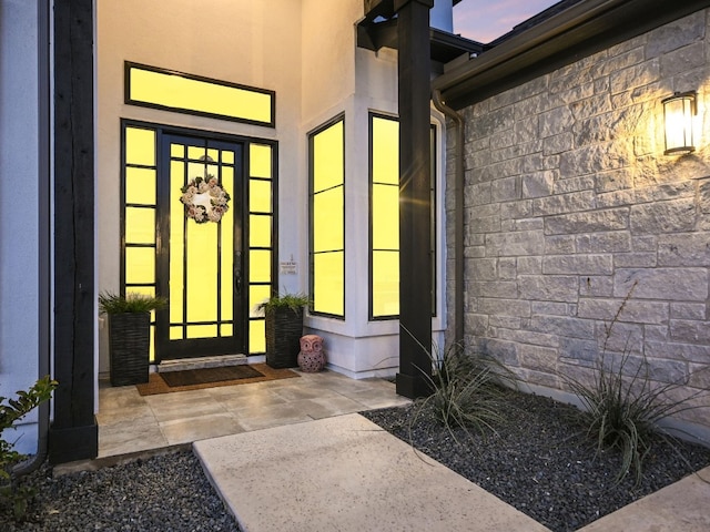 property entrance with stucco siding