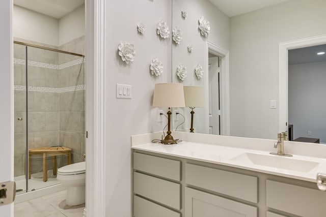 bathroom featuring vanity, tile patterned flooring, a shower with shower door, and toilet