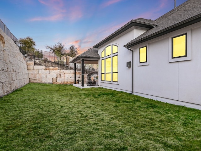 yard at dusk with a fenced backyard