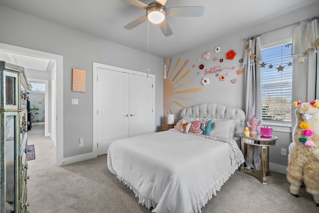 bedroom featuring light carpet, a ceiling fan, baseboards, a closet, and attic access