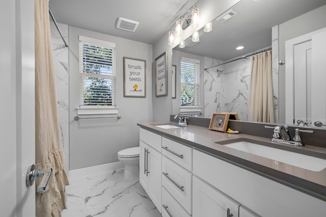 bathroom featuring tile patterned floors, double sink vanity, and toilet