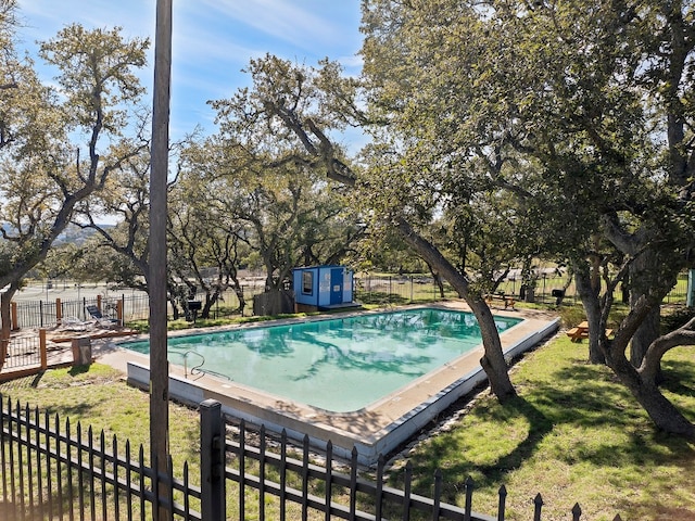 view of pool featuring a storage shed