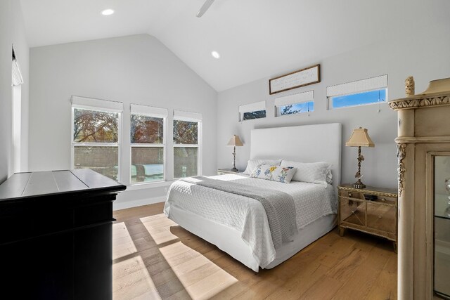 bedroom featuring light wood-style floors, high vaulted ceiling, and recessed lighting