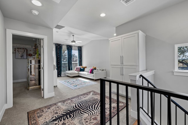 corridor with carpet floors and a wealth of natural light