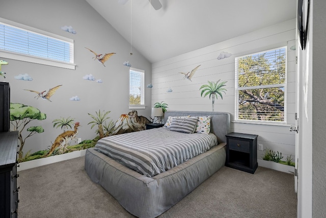 carpeted bedroom with ceiling fan and high vaulted ceiling