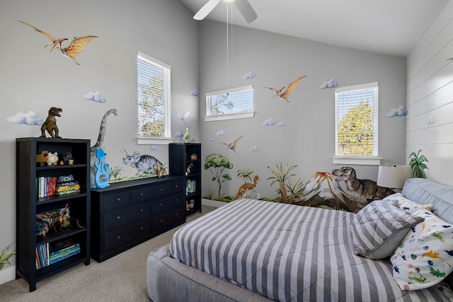 carpeted bedroom with lofted ceiling, multiple windows, and a ceiling fan