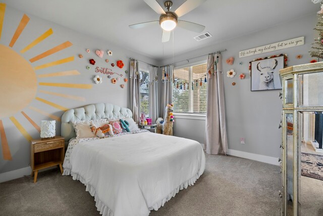 carpeted bedroom featuring visible vents, ceiling fan, and baseboards