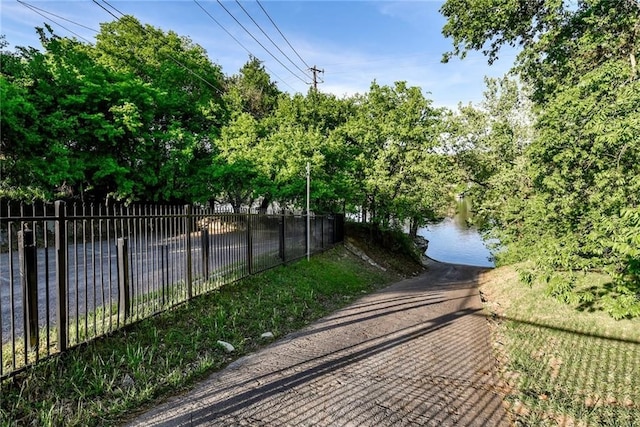 view of home's community with fence