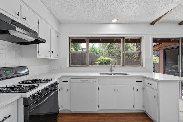 kitchen featuring sink, white cabinetry, white dishwasher, gas range oven, and kitchen peninsula