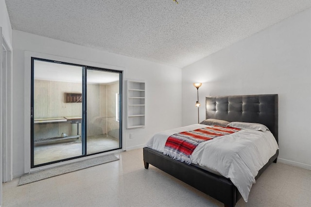 bedroom with baseboards and a textured ceiling