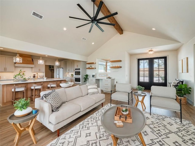 living room featuring french doors, beam ceiling, light hardwood / wood-style floors, ceiling fan, and high vaulted ceiling