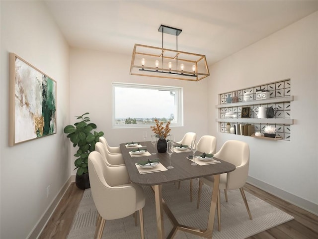 dining area with hardwood / wood-style floors and an inviting chandelier