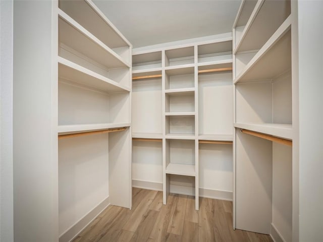 walk in closet with hardwood / wood-style floors