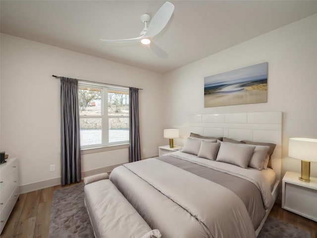 bedroom with dark hardwood / wood-style floors and ceiling fan