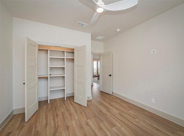 unfurnished bedroom with light hardwood / wood-style floors, a closet, and ceiling fan