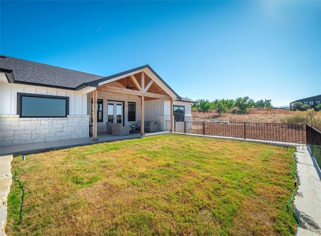 back of house featuring a yard