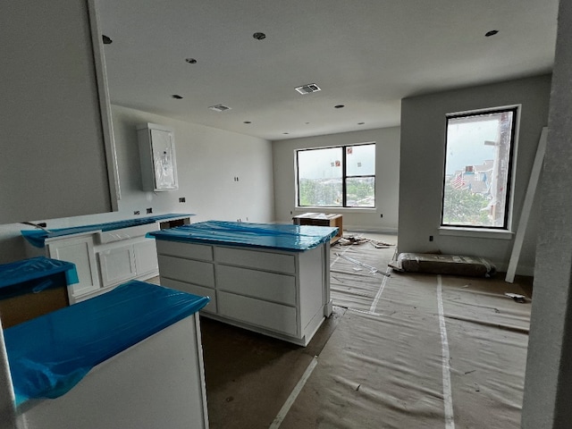 kitchen featuring white cabinets and a center island