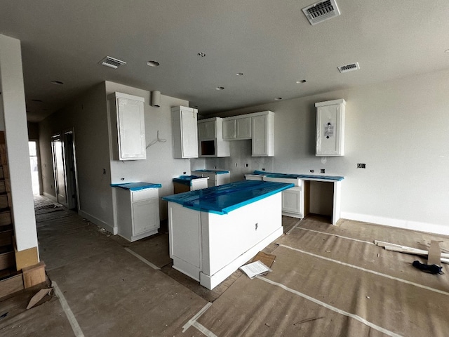 kitchen featuring a center island and white cabinetry