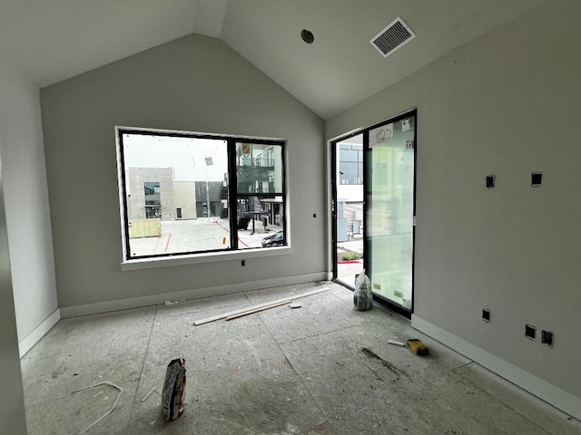 unfurnished room with plenty of natural light and vaulted ceiling