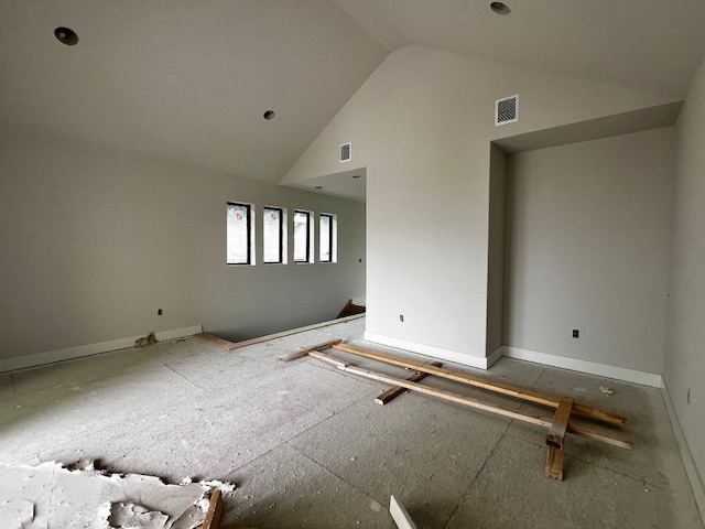 unfurnished room featuring high vaulted ceiling