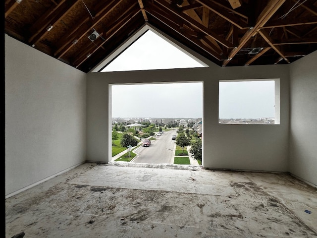 unfurnished room featuring vaulted ceiling