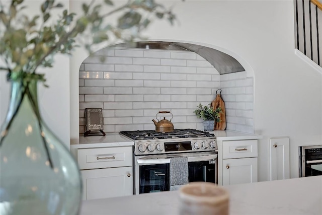 130 Overlook Dr, Fredericksburg, TX 78624 - kitchen with stainless steel range with gas cooktop, decorative backsplash, white cabinetry, and light countertops