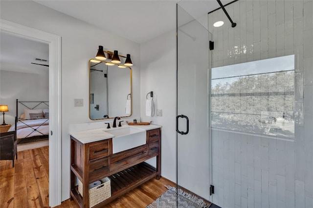 130 Overlook Dr, Fredericksburg, TX 78624 - ensuite bathroom featuring ensuite bath, wood finished floors, vanity, and a stall shower