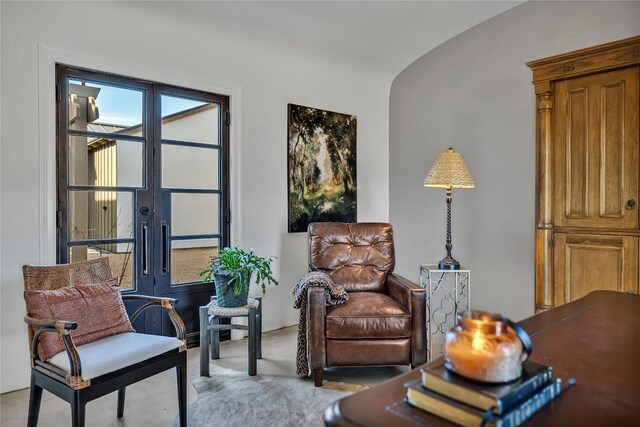 sitting room with lofted ceiling and french doors